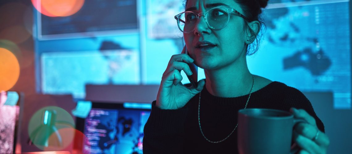 Night, coffee and a woman hacker on a phone call during a cyber security emergency in her office. C.